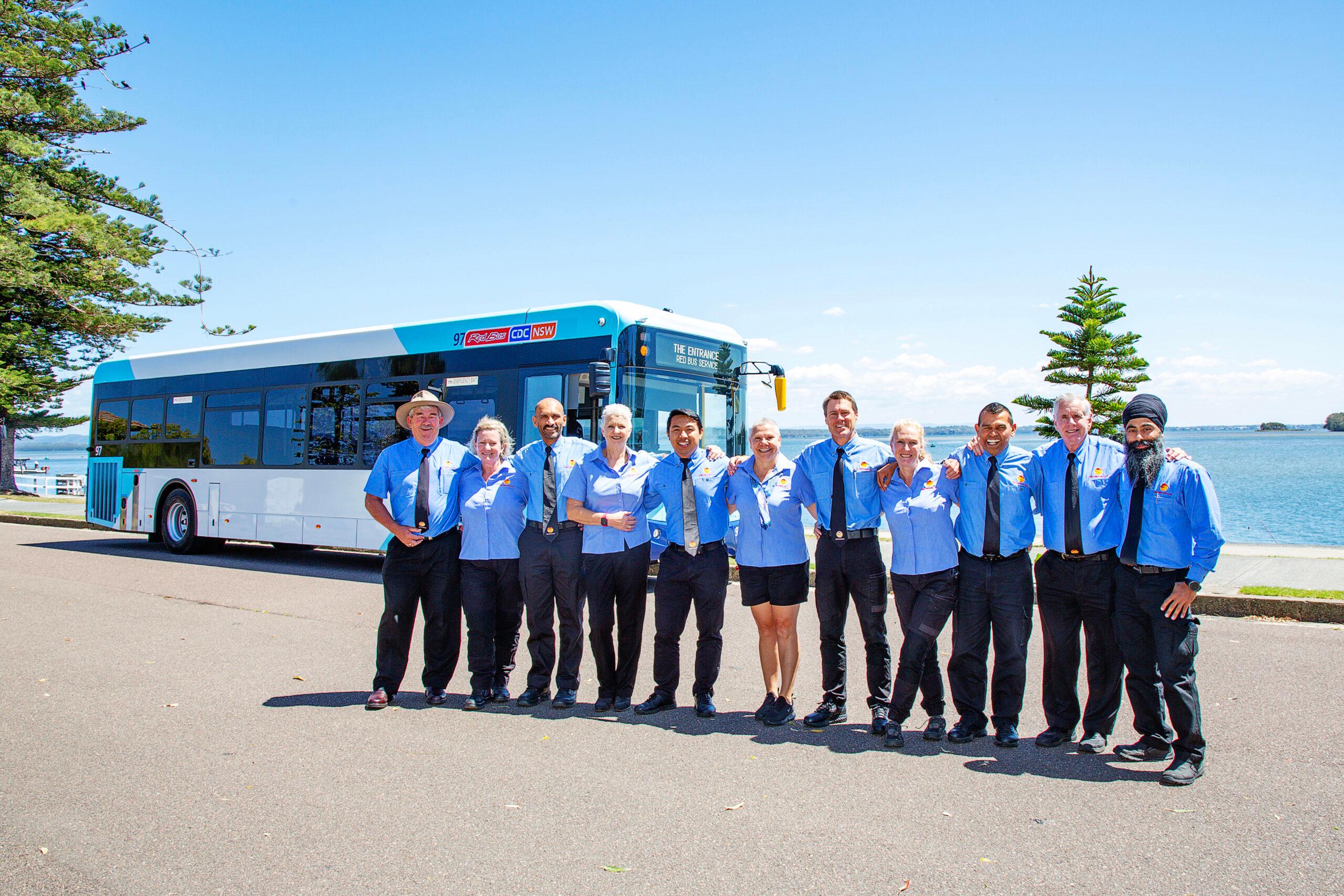 Staff standing in front of a bus